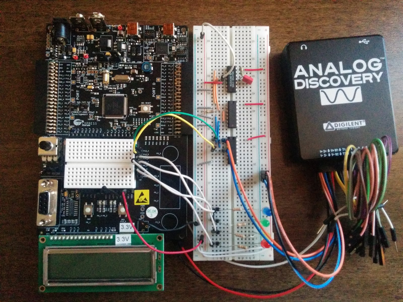 Networking Course Project (left Cypress PSoc, center custom hardware for network connection, right Analog Discover oscilloscope)