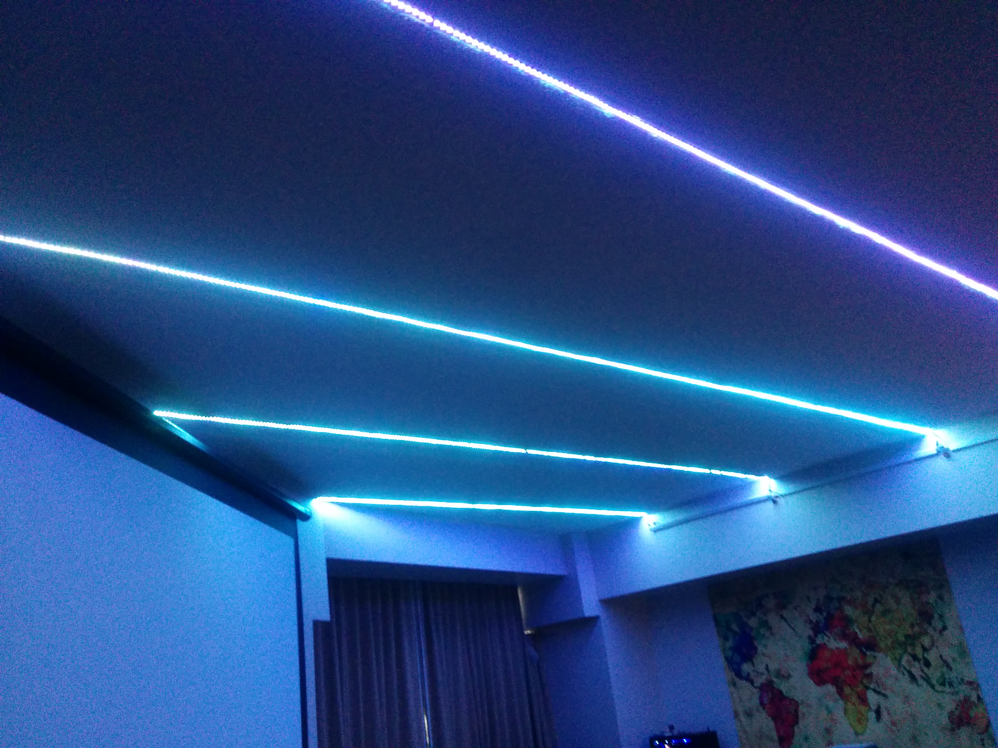 LED strips on ceiling of apartment with lighting effect control.